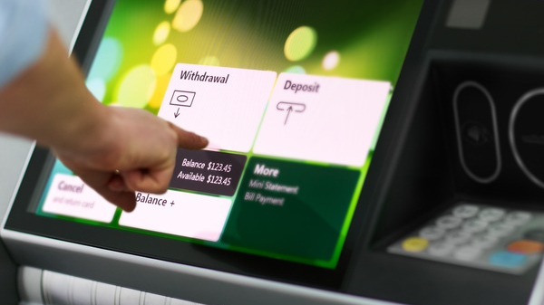 Image of person selecting transaction on ATM, Our expert integration team can develop all different kinds of software from, web, mobile, to embedded desktop applications and databases.