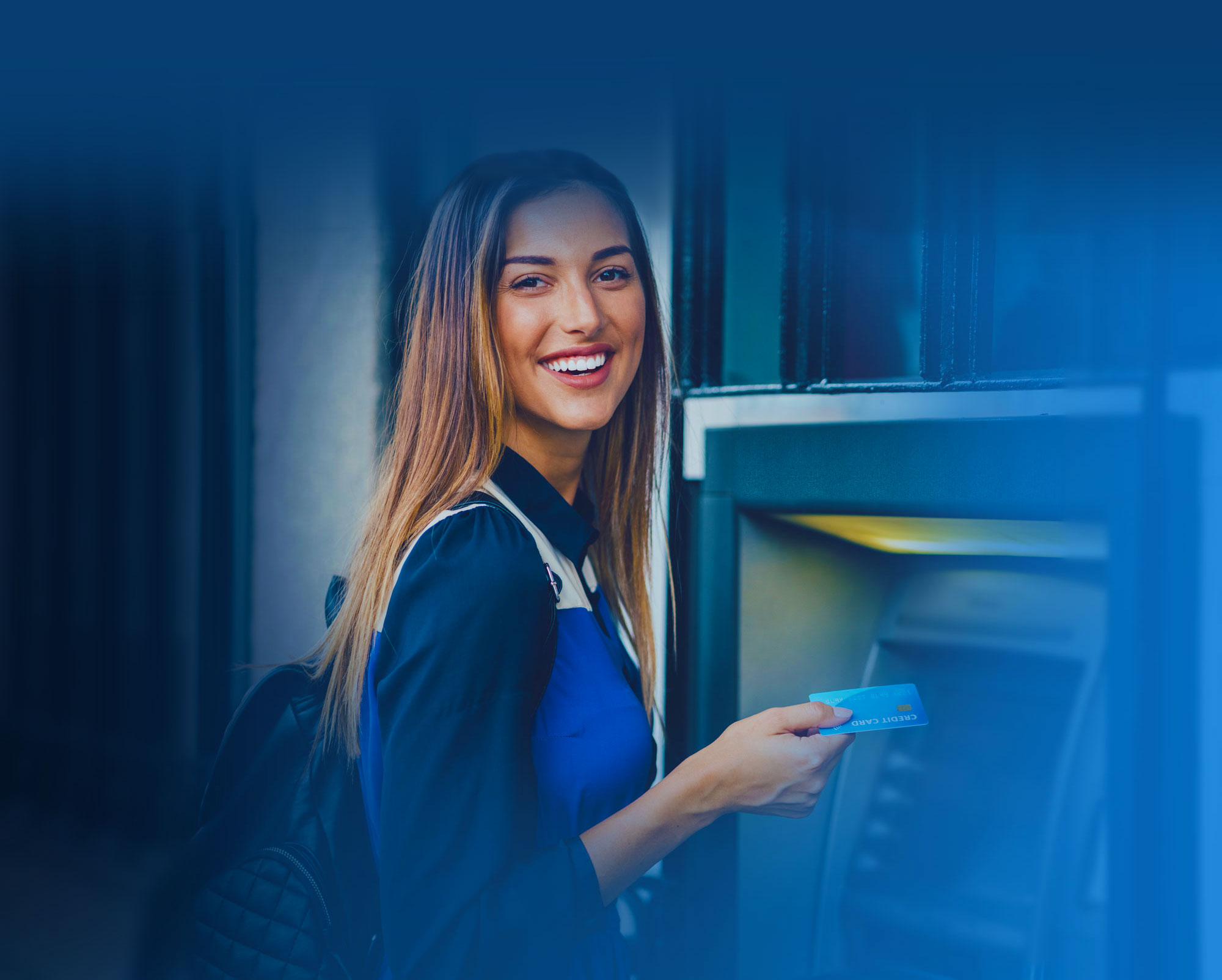 Young woman using an ATM. QSI, Inc. is a full-service provider of ATMs, ITMs, self-service technology and branch solutions, physical and logical security, maintenance and cash management for financial institutions, specializing in the community marketplace.